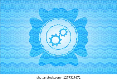 gear, team work icon inside sky blue water wave badge background.