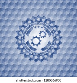 gear, team work icon inside blue emblem with geometric pattern.