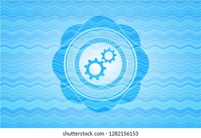 gear, team work icon inside sky blue water wave emblem background.