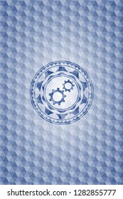 gear, team work icon inside blue emblem or badge with abstract geometric polygonal pattern background.