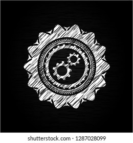 gear, team work icon inside chalkboard emblem written on a blackboard