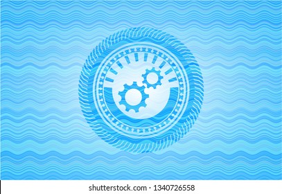 gear, team work icon inside water wave badge.