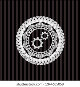 gear, team work icon inside silver emblem or badge
