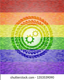 gear, team work icon inside emblem on mosaic background with the colors of the LGBT flag