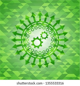 gear, team work icon inside green emblem with triangle mosaic background