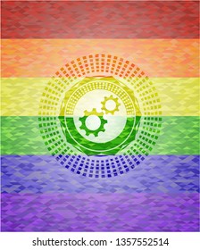 gear, team work icon inside emblem on mosaic background with the colors of the LGBT flag
