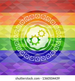 gear, team work icon inside emblem on mosaic background with the colors of the LGBT flag