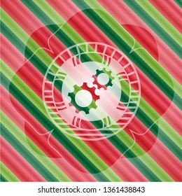 gear, team work icon inside christmas colors badge.