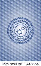 gear, team work icon inside blue badge with geometric background.