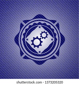 gear, team work icon inside badge with denim texture