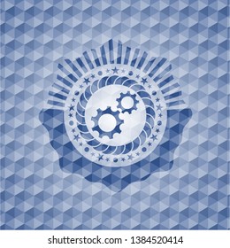 gear, team work icon inside blue emblem with geometric pattern.