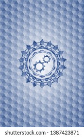 gear, team work icon inside blue emblem with geometric background.