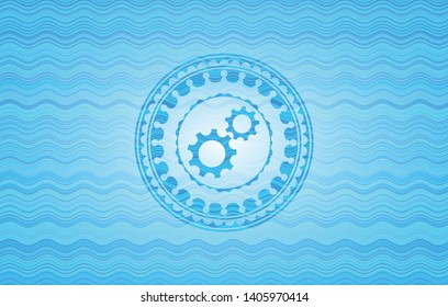 gear, team work icon inside sky blue water wave emblem background.