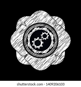 gear, team work icon inside chalkboard emblem written on a blackboard