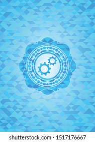 gear, team work icon inside light blue emblem with mosaic ecological style background