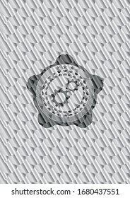 gear, team work icon inside silver shiny emblem. Scales pattern. Vector Illustration. Detailed.