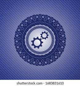 gear, team work icon inside badge with denim background