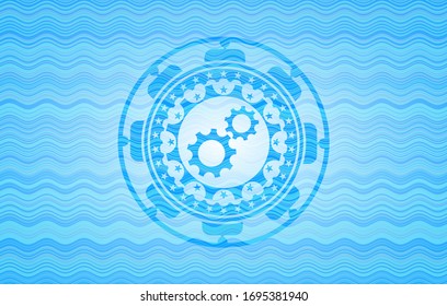Icono de trabajo en equipo dentro del emblema del estilo de agua azul claro.