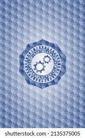 gear, team work icon inside blue emblem with geometric pattern. 
