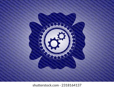 gear, team work icon inside emblem with denim texture. 