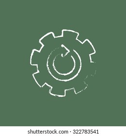 Gear wheel with arrow hand drawn in chalk on a blackboard vector white icon isolated on a green background.