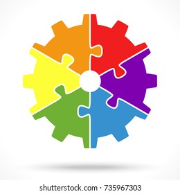 gear wheel with six colored puzzle parts for cooperation or teamwork symbolism