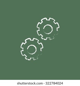 Gears hand drawn in chalk on a blackboard vector white icon isolated on a green background.