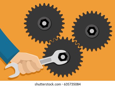 Gears and hand with a wrench.