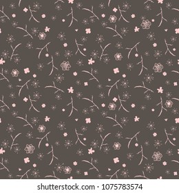A gentle seamless floral pattern in many varieties of wildflowers. Pink silhouettes of plants scattered randomly on a dark background.Vector for fashion prints, textiles, wallpapers, tiles, paper.