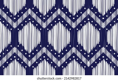 Geometric ethnic oriental ikat pattern design. Design for fabric, clothing, carpat. White woven motifs on blue background.