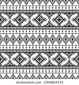 Geometric ethnic tribal seamless pattern in black and white color. Aztec stylized print template for textile design, fabric, clothes, curtain, carpet, batik, ornament, wallpaper, wrapping, paper.