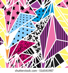 Geometric modern seamless pattern with lilac, white, yellow, orange, red, pink, black and blue shapes arranged in a random order. Vector illustration.