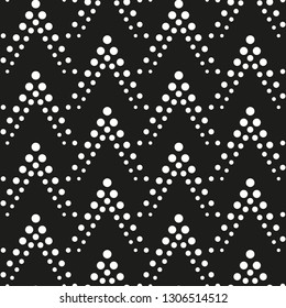 Geometric ornament of dots. Pattern of white dots on a black background. Vector seamless pattern.
