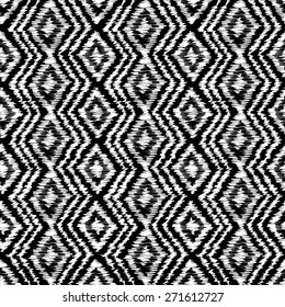 Geometric seamless ornamental background with zigzag line and rhombus in black and white colors. Vector. Ethnic textile pattern.