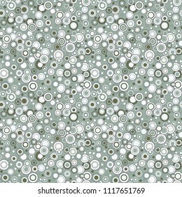 Geometric seamless pattern. Circles and rings are chaotically located on a green background. Useful as design element for texture and artistic compositions.