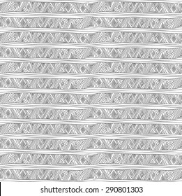 Geometric seamless pattern in ethnic style. The complex structure of triangles, diamonds and stripes painted hands.