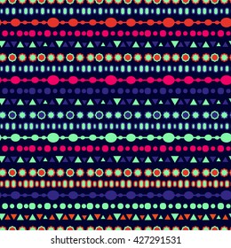 Geometric seamless pattern in ethnic style. Bright colorful shapes triangles, squares, ovals, circles strips and zigzags on a dark background.