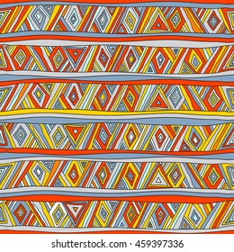Geometric seamless pattern in ethnic style. Tribal, folk traditional motifs. Triangles, zigzags, stripes. Cheerful motley color.