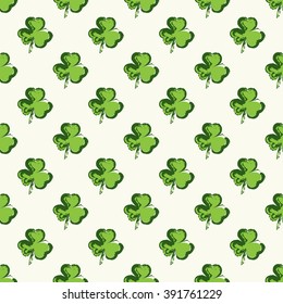 Geometric seamless pattern with green clover for St. Patrick's Day on a light background. 