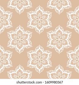Geometric seamless pattern in indian style. White design on beige background. Vector illustration