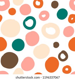 Geometrical background with uneven circles. Abstract round seamless pattern. Hand drawn colorful dots pattern on white background. Vector illustration.