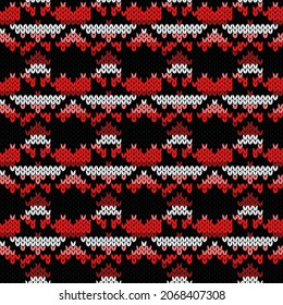 Geometrical ornate seamless knitted vector pattern as a fabric texture in red, pink, black and white colors