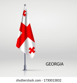 Georgien hängt Flagge auf Flagpol
