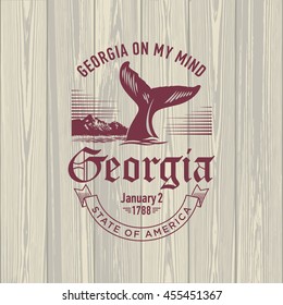 Georgia on my Mind, stylized emblem of the state of America, whale, on wooden background
