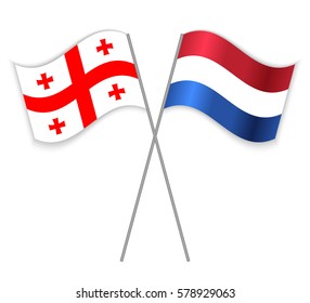 Georgian and Dutch crossed flags. Georgia combined with Netherlands isolated on white. Language learning, international business or travel concept.