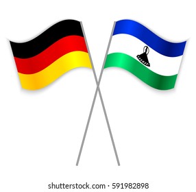 German and Basotho crossed flags. Germany combined with Lesotho isolated on white. Language learning, international business or travel concept.