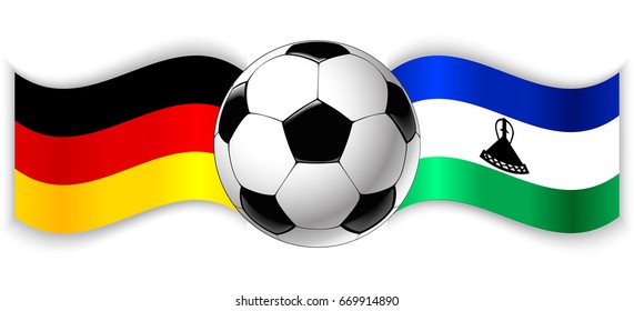 German and Basotho wavy flags with football ball. Germany combined with Lesotho isolated on white. Football match or international sport competition concept.