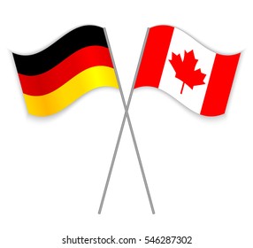 German and Canadian crossed flags. Germany combined with Canada isolated on white. Language learning, international business or travel concept.