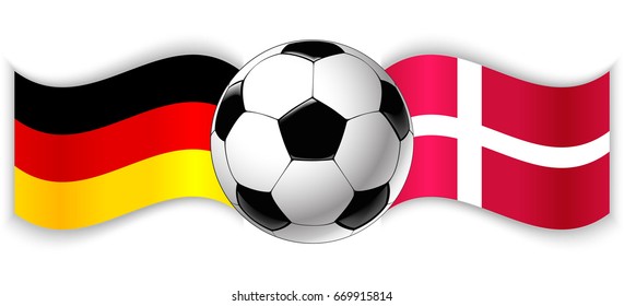 German and Danish wavy flags with football ball. Germany combined with Denmark isolated on white. Football match or international sport competition concept.