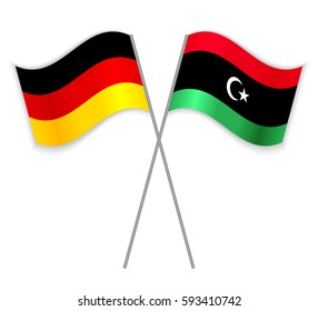 German and Libyan crossed flags. Germany combined with Libya isolated on white. Language learning, international business or travel concept.